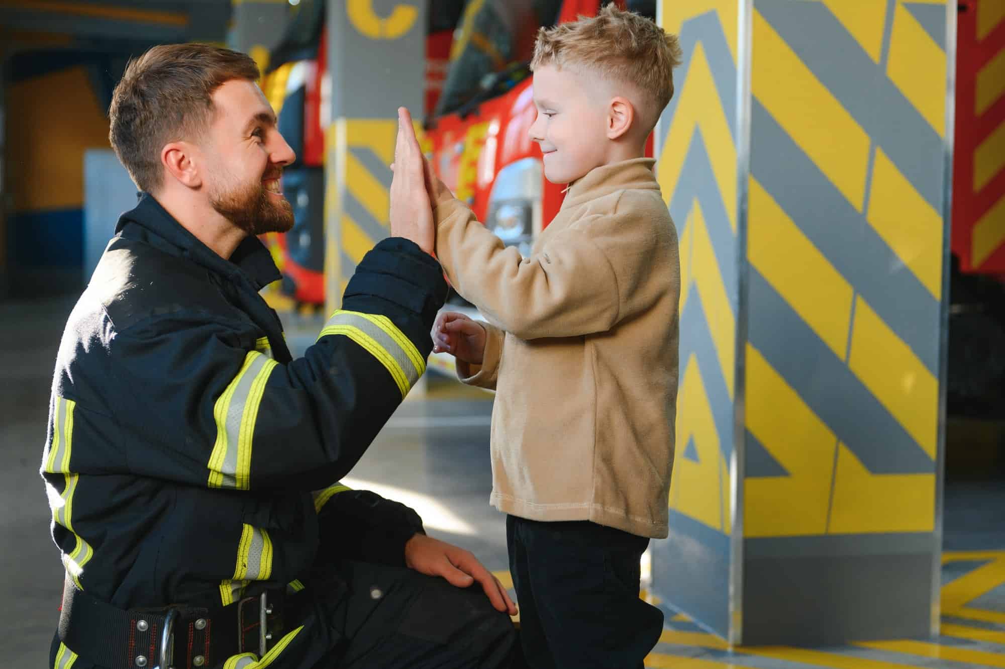 Firefighter holding child boy to save him in fire and smoke,Firemen rescue the boys from fire