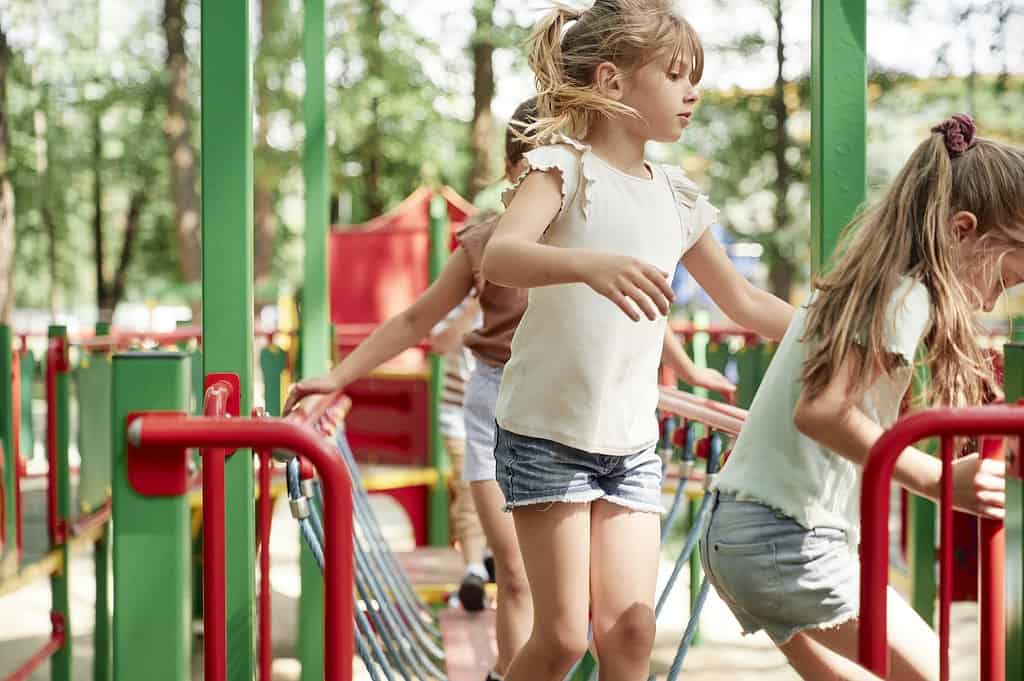 Group of kids playing at the playground in summer day