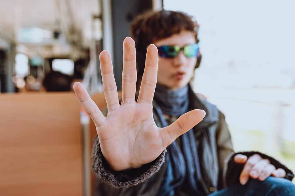 hand outstretched to camera, ban on photography